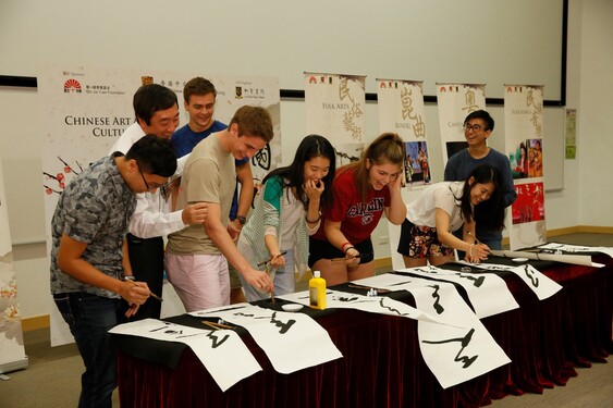 The students are excited to be writing Chinese calligraphy with Professor Sung.